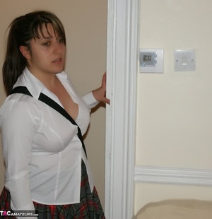 Teen babe with chubby body in white blouse, gray and red skirt, white socks and black and white rubber shoes goes into her step dad's bedroom and reads a porn magazine. - Picture 3