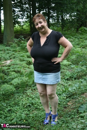 Mature BBW displays her plus size body in black shirt, jeans skirt and blue high heels then shows her extra large boobs in the woods. - XXXonXXX - Pic 1