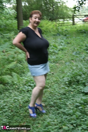 Mature BBW displays her plus size body in black shirt, jeans skirt and blue high heels then shows her extra large boobs in the woods. - XXXonXXX - Pic 3