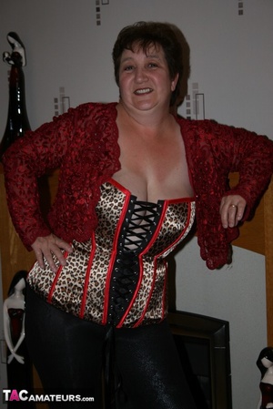 Chubby granny takes off her red blouse and displays her big body before she takes off her multi colored leopard print corset and expose her large breasts in different poses wearing her black leggings and brown and black high heels on the floor. - XXXonXXX - Pic 5
