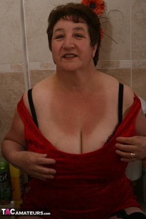 Alluring granny peels off her red dress and seduces with her plus size body in red and black lingerie, black stockings and red high heels in different poses in the bathroom. - XXXonXXX - Pic 14