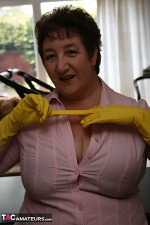 Mature plomper displays her chubby body in pink shirt, gray skirt, underwear, pink stockings and gray high heels in different poses in her kitchen. - XXXonXXX - Pic 5