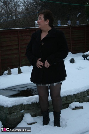 Gorgeous plomper slowly takes off her black coat, shirt and black and white skirt then displays her chubby body in red lingerie, black stockings and boots before she expose her monster boobs and sweet crack in the snow. - XXXonXXX - Pic 1