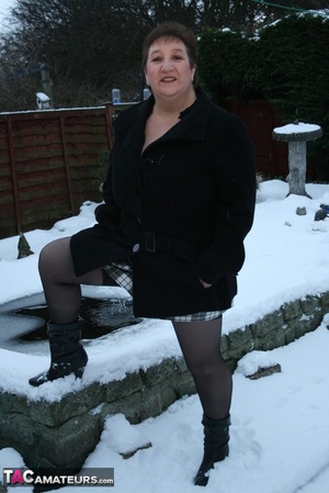 Gorgeous plomper slowly takes off her black coat, shirt and black and white skirt then displays her chubby body in red lingerie, black stockings and boots before she expose her monster boobs and sweet crack in the snow. - XXXonXXX - Pic 2