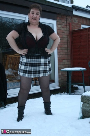 Gorgeous plomper slowly takes off her black coat, shirt and black and white skirt then displays her chubby body in red lingerie, black stockings and boots before she expose her monster boobs and sweet crack in the snow. - XXXonXXX - Pic 5