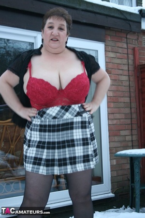 Gorgeous plomper slowly takes off her black coat, shirt and black and white skirt then displays her chubby body in red lingerie, black stockings and boots before she expose her monster boobs and sweet crack in the snow. - XXXonXXX - Pic 6