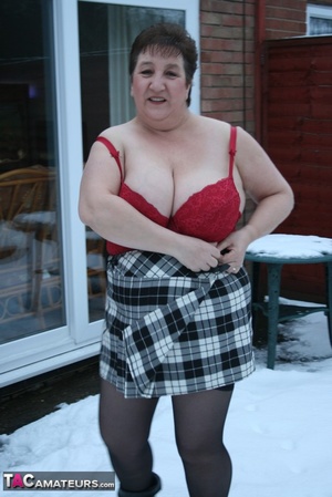 Gorgeous plomper slowly takes off her black coat, shirt and black and white skirt then displays her chubby body in red lingerie, black stockings and boots before she expose her monster boobs and sweet crack in the snow. - XXXonXXX - Pic 9