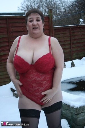 Gorgeous plomper slowly takes off her black coat, shirt and black and white skirt then displays her chubby body in red lingerie, black stockings and boots before she expose her monster boobs and sweet crack in the snow. - XXXonXXX - Pic 11