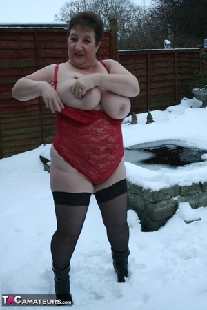 Gorgeous plomper slowly takes off her black coat, shirt and black and white skirt then displays her chubby body in red lingerie, black stockings and boots before she expose her monster boobs and sweet crack in the snow. - XXXonXXX - Pic 12