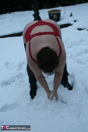 Gorgeous plomper slowly takes off her black coat, shirt and black and white skirt then displays her chubby body in red lingerie, black stockings and boots before she expose her monster boobs and sweet crack in the snow. - XXXonXXX - Pic 17