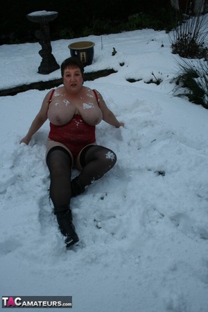 Gorgeous plomper slowly takes off her black coat, shirt and black and white skirt then displays her chubby body in red lingerie, black stockings and boots before she expose her monster boobs and sweet crack in the snow. - XXXonXXX - Pic 19
