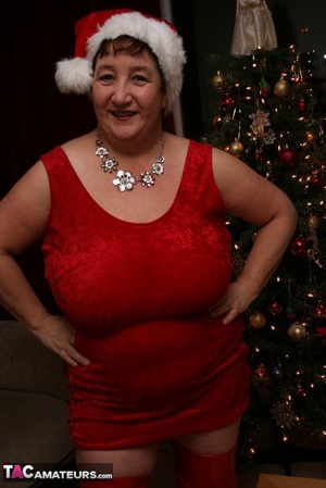 Mature plomper displays her large body in red santa hat, dress, panty and boots on a gray and brown couch before she reveals her monster boobs and juicy pussy in different poses. - XXXonXXX - Pic 3