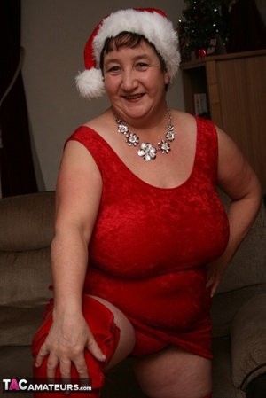 Mature plomper displays her large body in red santa hat, dress, panty and boots on a gray and brown couch before she reveals her monster boobs and juicy pussy in different poses. - XXXonXXX - Pic 5