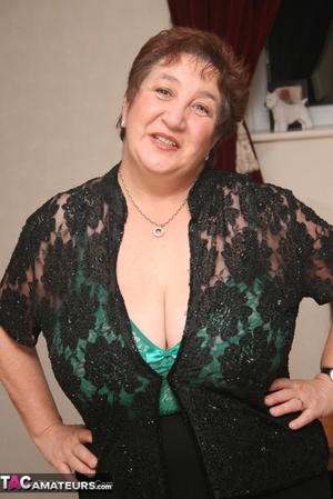 Steaming hot granny peels off her black blouse and skirt then pose her plus size body in green lingerie, black stockings and high heels. - XXXonXXX - Pic 1