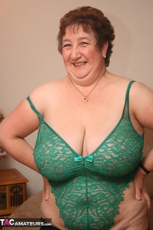 Steaming hot granny peels off her black blouse and skirt then pose her plus size body in green lingerie, black stockings and high heels. - XXXonXXX - Pic 19