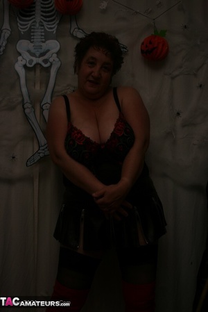 Hot granny takes off her black jacket and teases with her monster tits and chubby body in red and black lingerie, black skirt, stockings and red boots. - XXXonXXX - Pic 13
