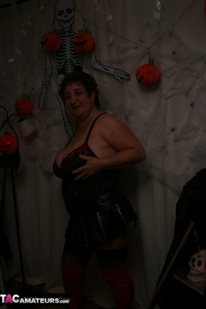 Hot granny takes off her black jacket and teases with her monster tits and chubby body in red and black lingerie, black skirt, stockings and red boots. - XXXonXXX - Pic 15