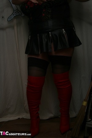 Hot granny takes off her black jacket and teases with her monster tits and chubby body in red and black lingerie, black skirt, stockings and red boots. - XXXonXXX - Pic 17