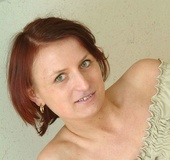 Mature brunette sheds her white undies and toying her bushy vagina with