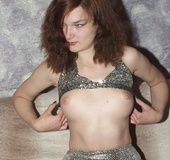 Busty brunette taking off her shiny outfit and black panty before showing