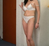 Black haired babe sheds her blue top and white undies before posing nude