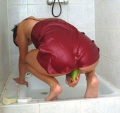 Short haired brunette taking a shower in red peignoir before sucking and