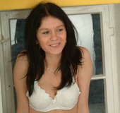 Black haired gf in pantyhose and white bra stipteasing in the bedroom