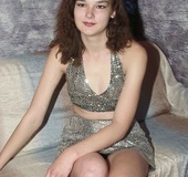 Brown eyed brunette in shiny outfit sheds black panty and nylons to show