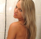 Naked blonde with big boobs taking a shower and teasingly posing just