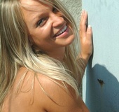 Big tits blonde in jeans skirt and blue top strips on the roof before