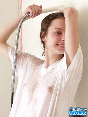 Brunette teen with perky tits and hairy coochie teasing in wet t-shirt while taking a bath - Picture 2
