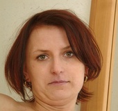 Small tits milf in sexy outfit posing by the mirror before undressing