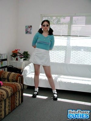 Pigtailed brunette in sunglasses sheds blue top and white miniskirt just to show her big tits and hairy cunt by the white couch - XXXonXXX - Pic 9