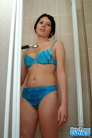Busty black haired gal in blue bikini slowly undressing in the shower and fingering her bushy snatch - Picture 7