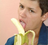 Short haired brunette in jeans outfit and black panty eating banana and