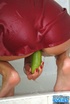 Short haired brunette in red peignoir toying her hairy pussy with cucumber