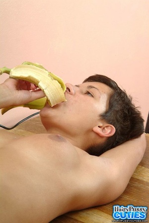 Short haired brunette in black undies and jeans outfit eating banana before posing naked on the table and fingering her bushy cunt - Picture 6