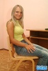 Busty blonde in white underwear and black heels posing on the table before