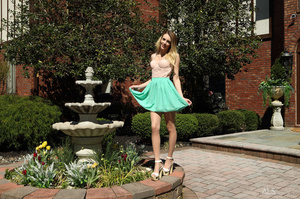 Young blonde in pink top and green skirt - Picture 1