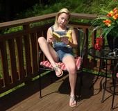 Small boobed blonde in jeans outfit and yellow t-shirt undressing on the