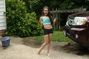 Grey eyed brunette washing car outdoors  - Picture 1