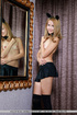 Blonde gal in black socks and cat ears on her head taking off black miniskirt