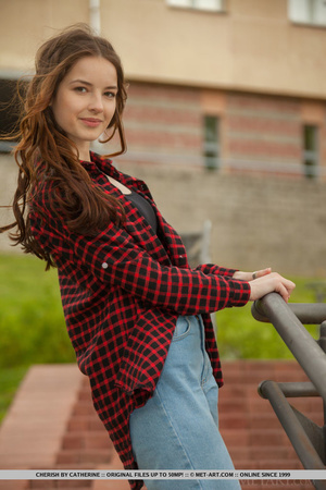 Brunette teen in jeans and red shirt pos - Picture 1