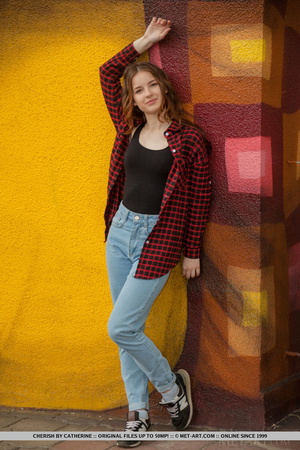 Brunette teen in jeans and red shirt pos - Picture 2