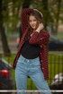 Brunette teen in jeans and red shirt posing outdoors before teasing naked