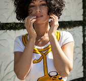 Curly hair wiggles out of tight pants and white top just to show her huge