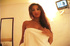 Hot tanned asian babe in a towel takes it off to show the goods