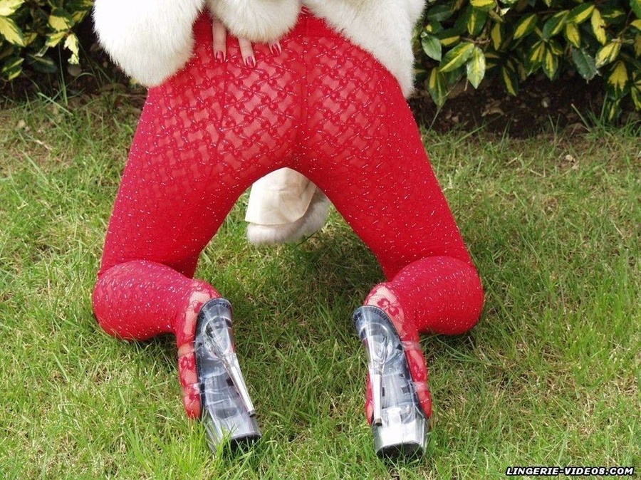 Alluring babe pose her stunning body outdoor wearing her white furry coat, red bra and glass high heels before she pulls down her red pantyhose and bares her indulging pussy on the grass. - XXXonXXX - Pic 2