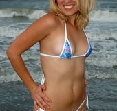 Smoking hot blonde in blue and white bikini gets wet as she displays her