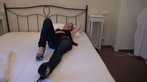 Matured short golden haired blonde is lying on the bed with her latex suit - Picture 6